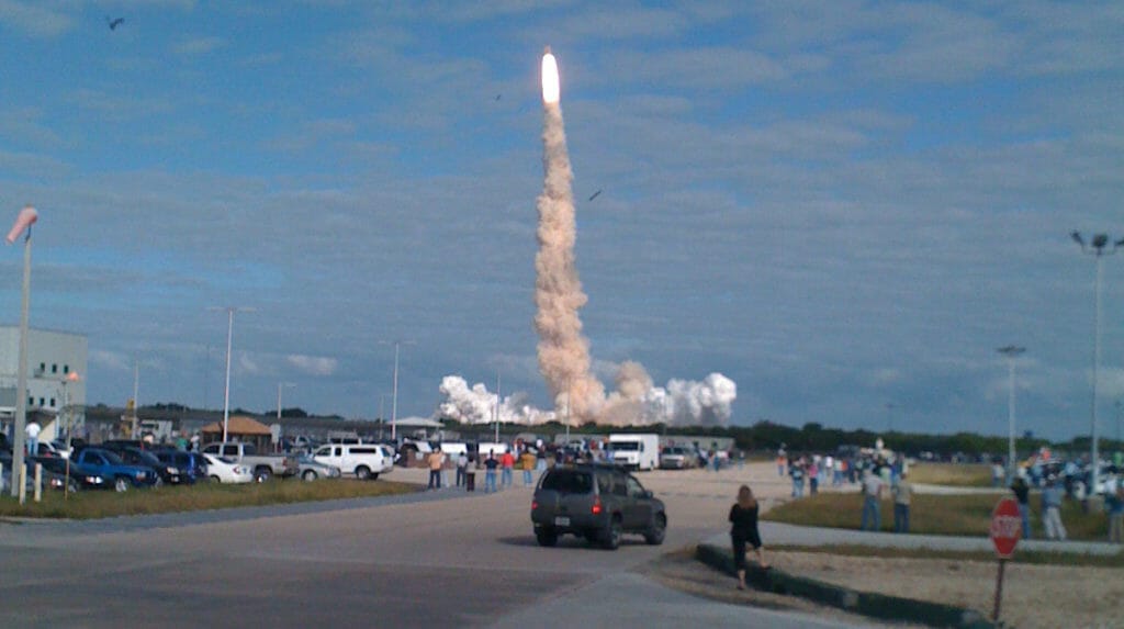 Workers at Kennedy Space Center watch a shuttle launch up close