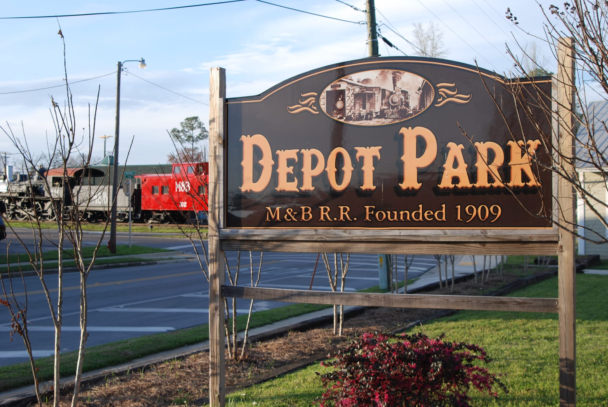 Depot Park sign with train beyond