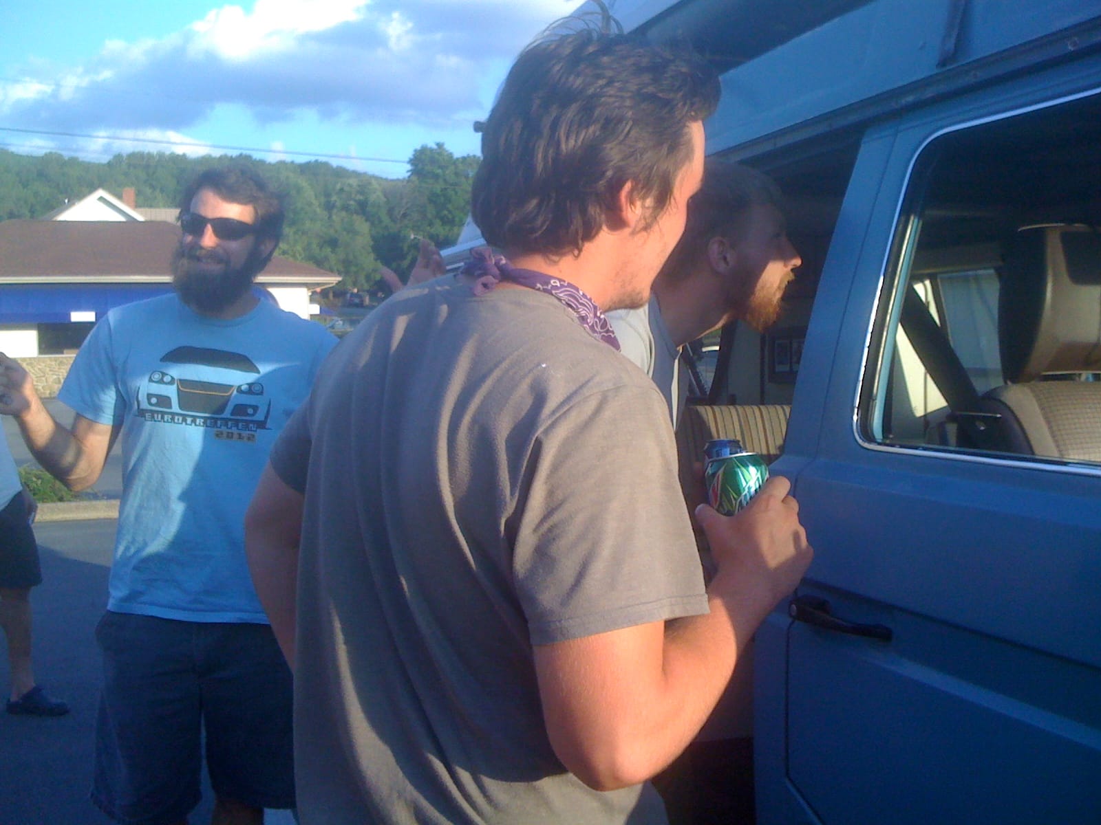 People peeking inside a VW Westphalia camper