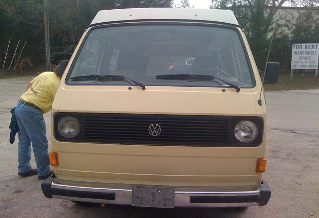Man looking inside classic VW Westfalia with excellent body and original paint