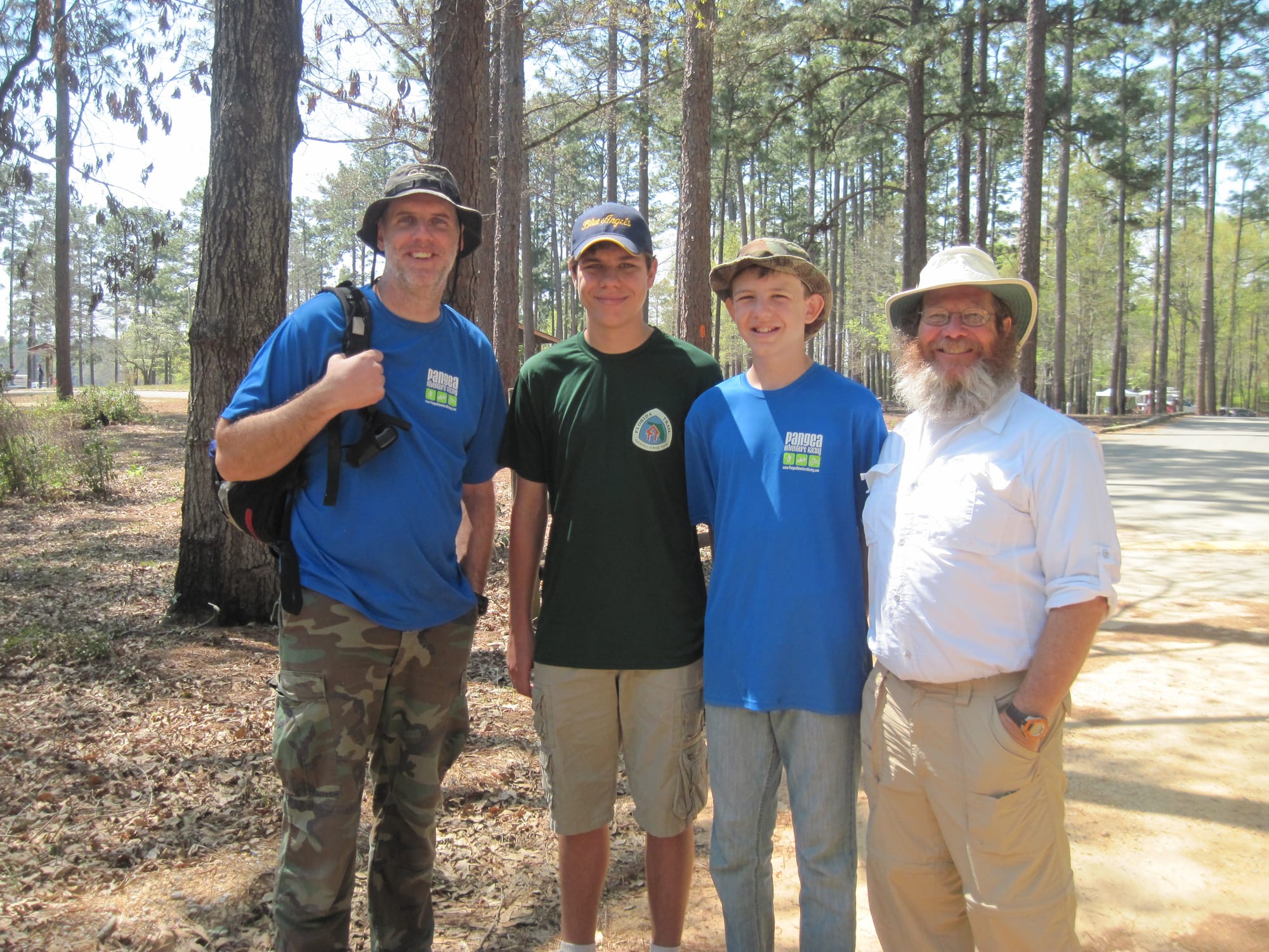 Two men and two young men at a campground, posing