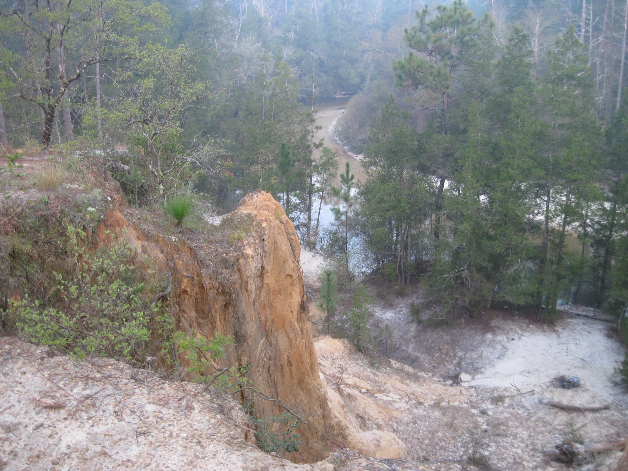 A smoky day at clay cliffs eroding into a creek basin