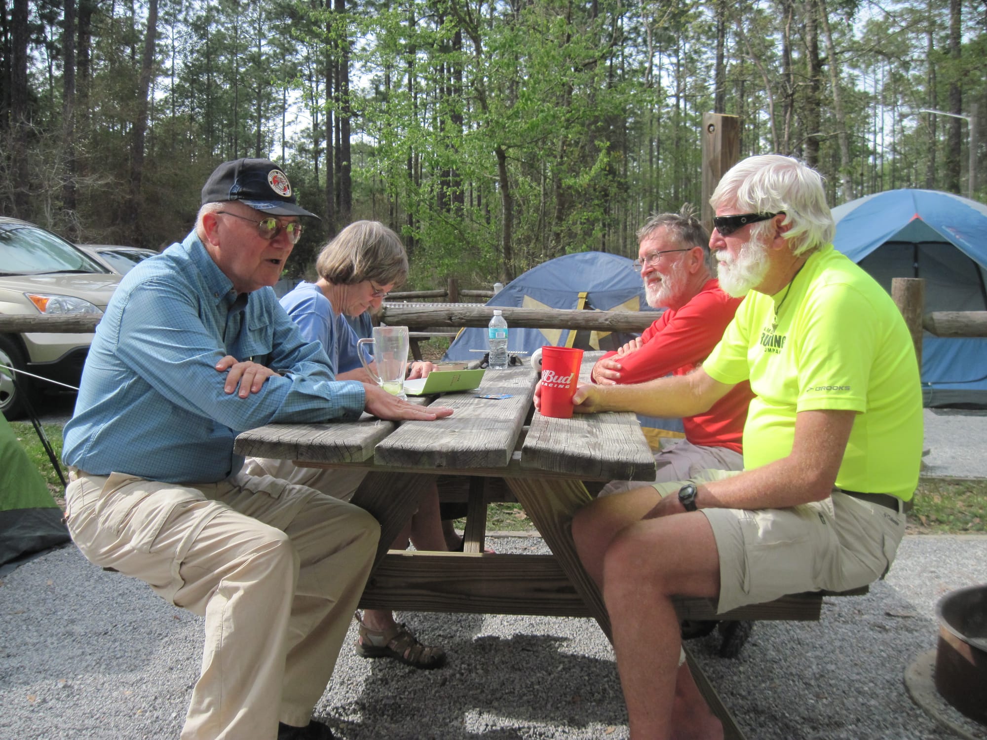 People enjoying a picnic table in a campground