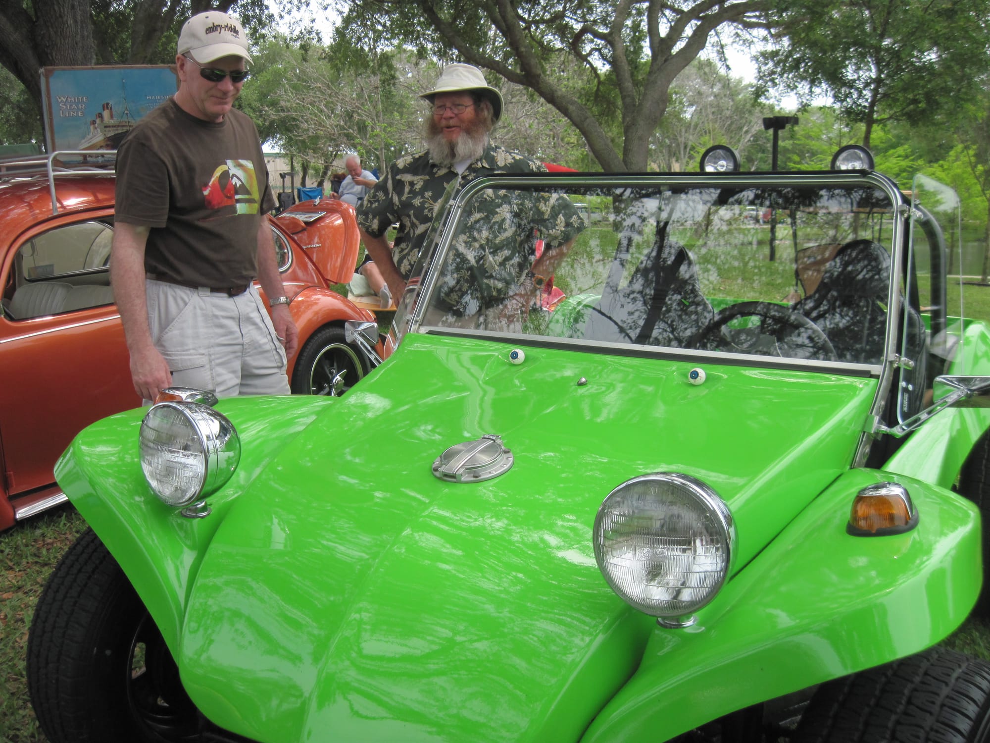 Men talking next to a dune buggy