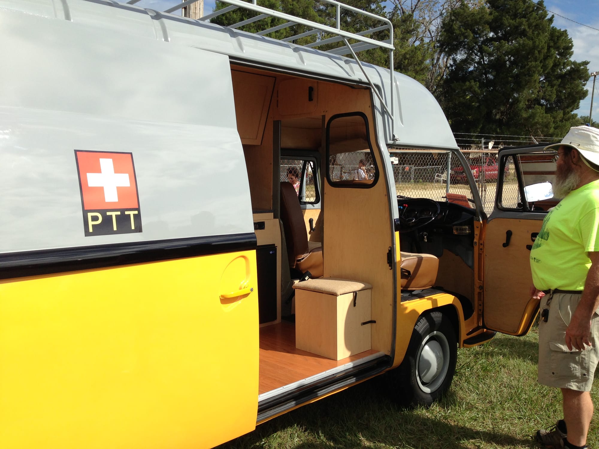 Man looking at converted postal van