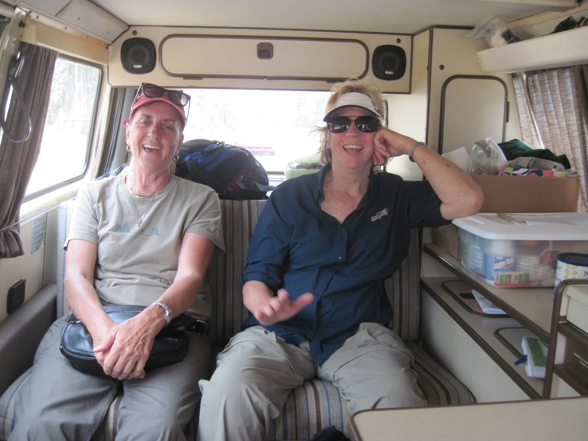 Two women on a bench seat in a VW camper van