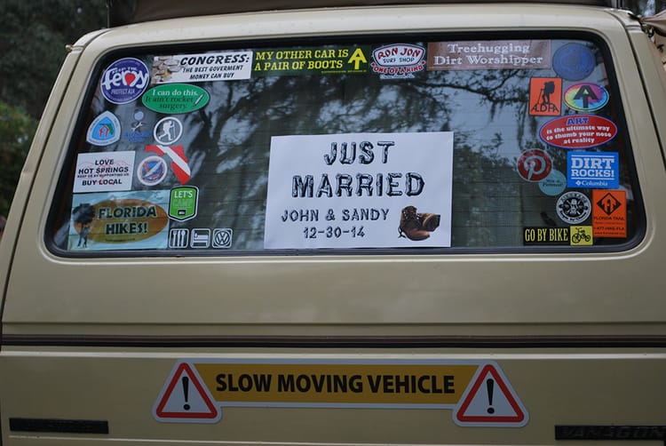 Just Married sign in Westfalia back window among many stickers