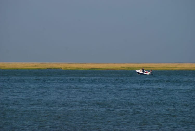 Lone boat in a vast estuary