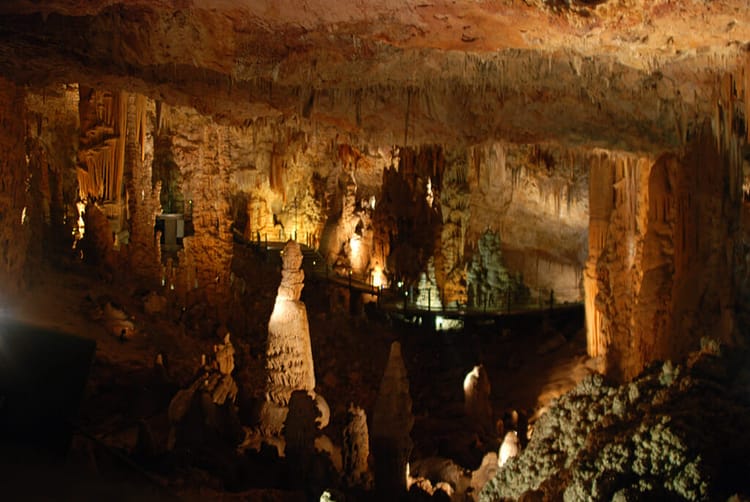 Massive underground natural chamber with cave formations and raised walkways