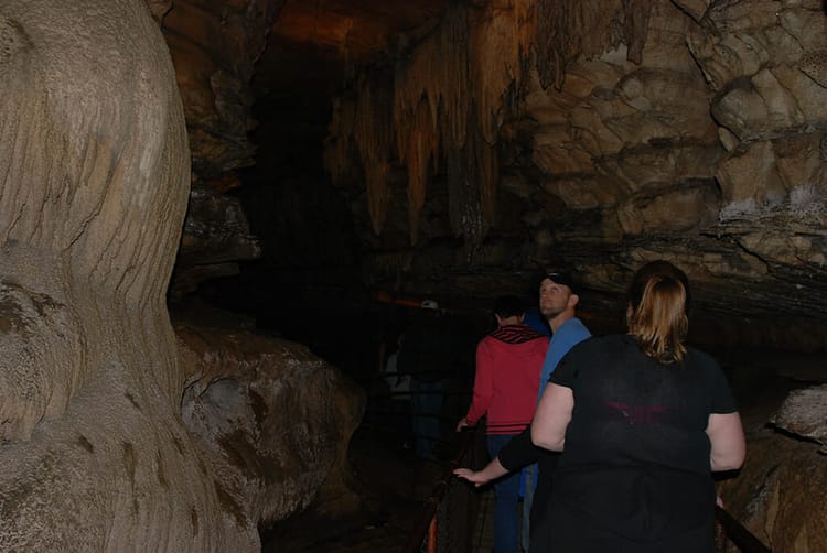 People walking through a cave passage