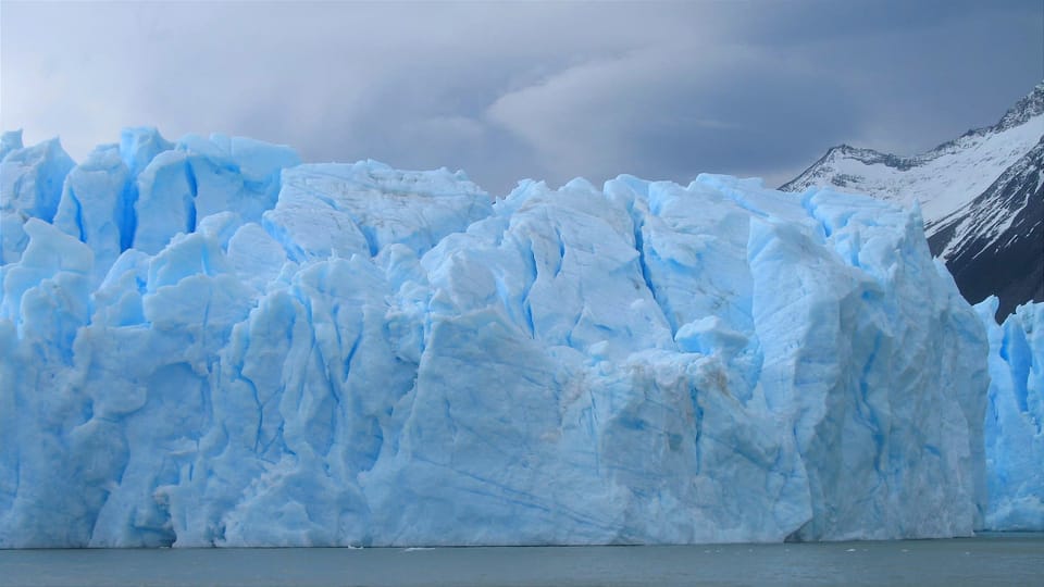 A wall of blue fractured ice on a glacier